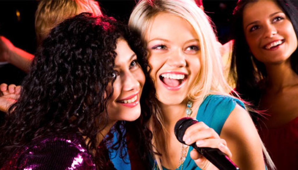 Photo of pretty girls with microphone singing in it
