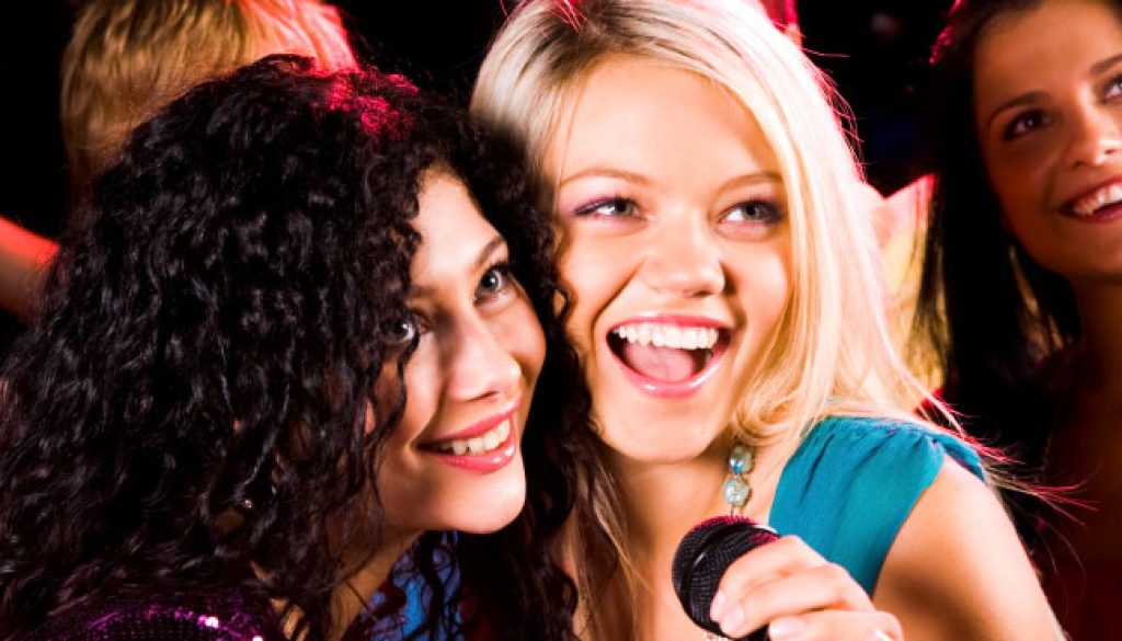 Photo of pretty girls with microphone singing in it